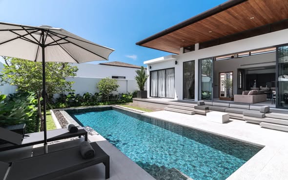 for Rent Modern loft-style villa with a private pool, high ceilings, and spacious living areas, located in a peaceful gated community